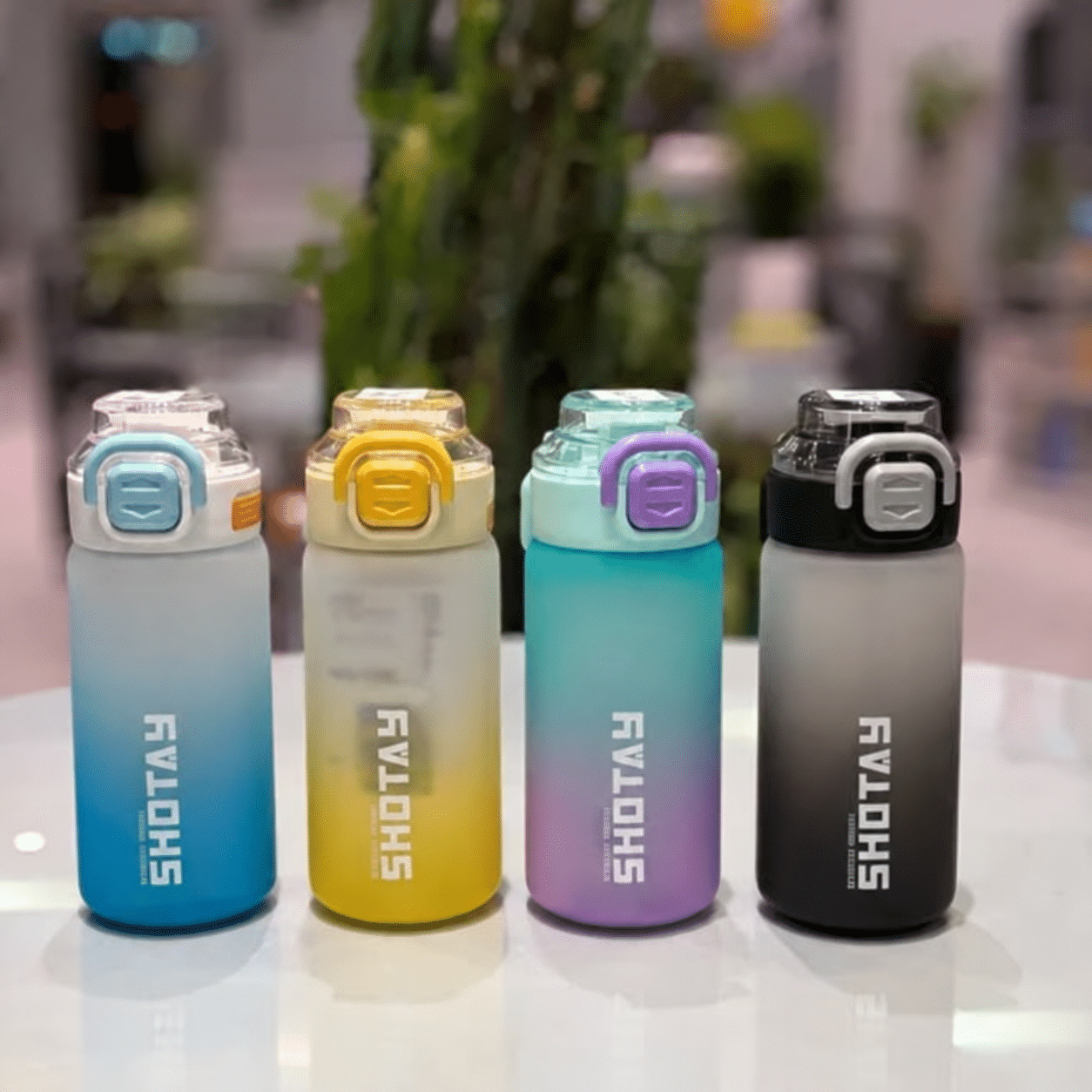 Four Colorful Water Bottles on Tabletop قمقمه شوتای 600 میل - تصویر 1